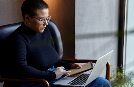 Woman with Glasses on Laptop